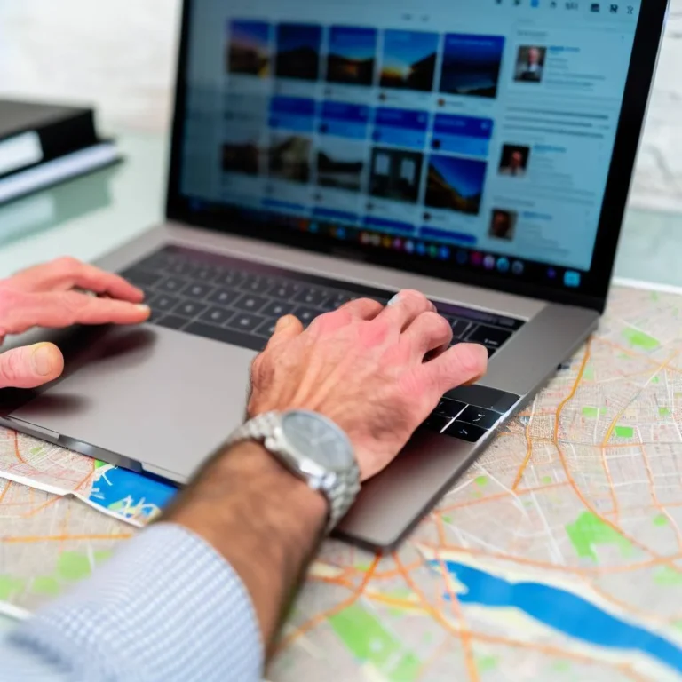 a real estate agent sitting at a desk with a laptop, surrounded by maps and property listings, typing on a keyboard with a determined expression